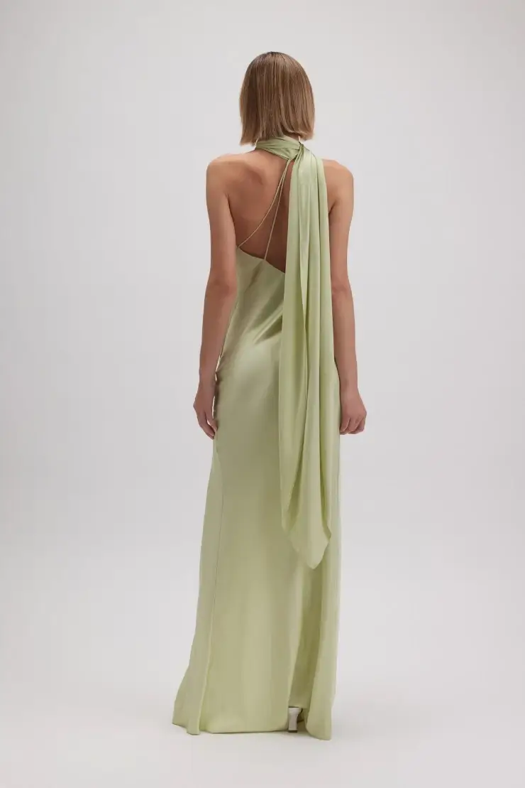 model is wearing a one shoulder green evening dress