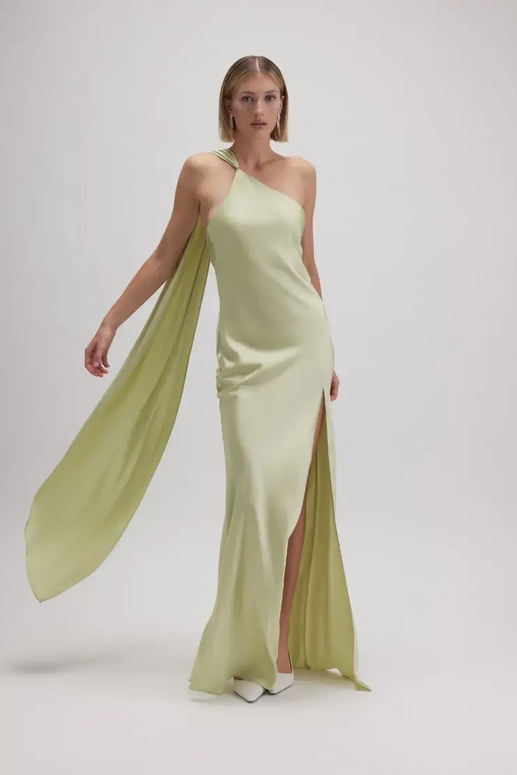 model is wearing a one shoulder green evening dress