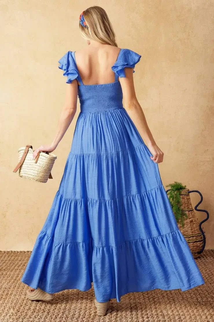 model is wearing a blue a-line evening dress with cap flutter sleeves