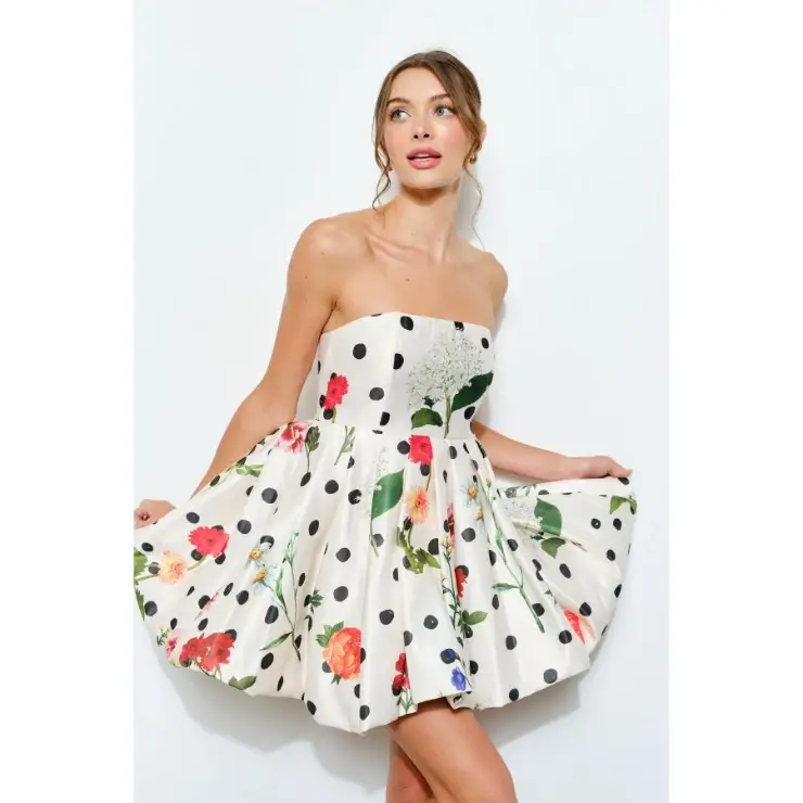 model is wearing a floral strapless mini dress
