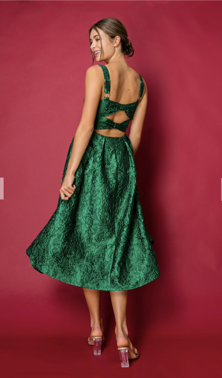 model is wearing a green sleeveless tea length brocade evening dress