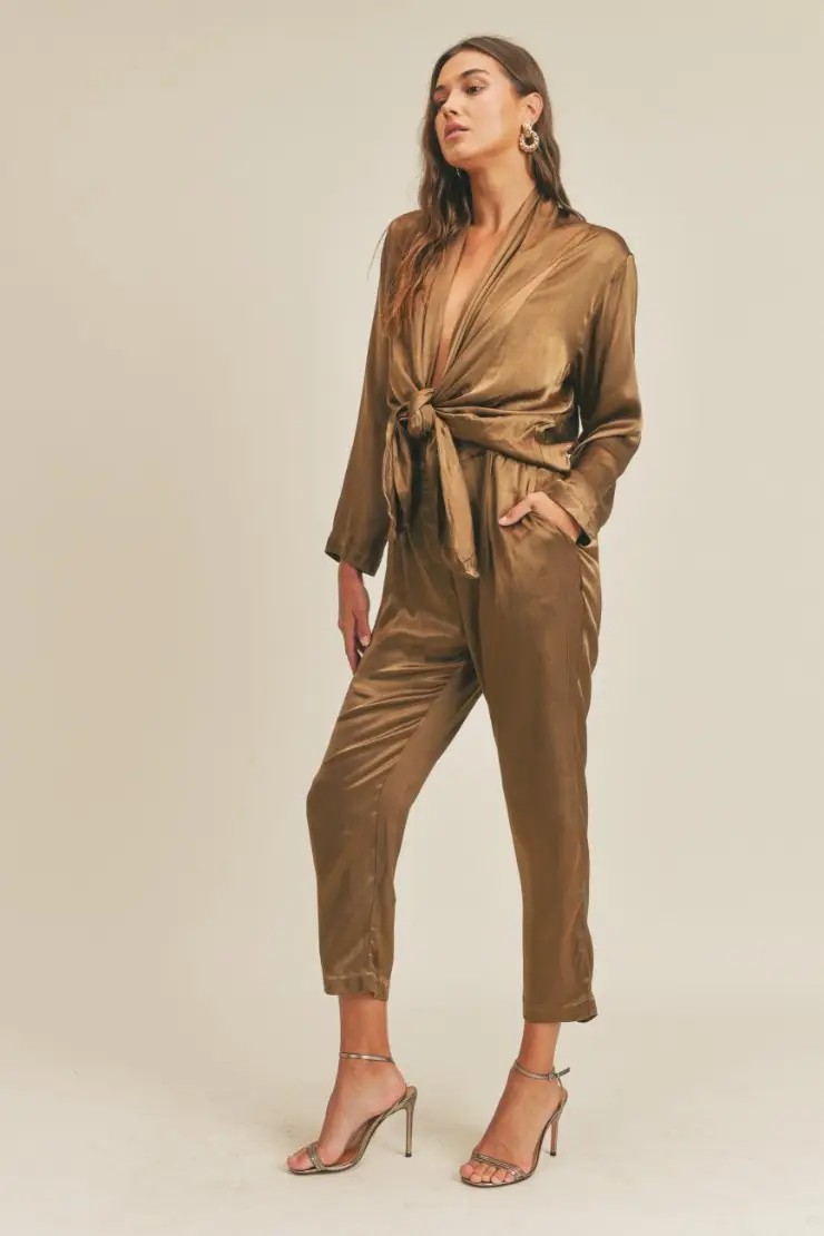 Model is wearing an olive green jumpsuit 