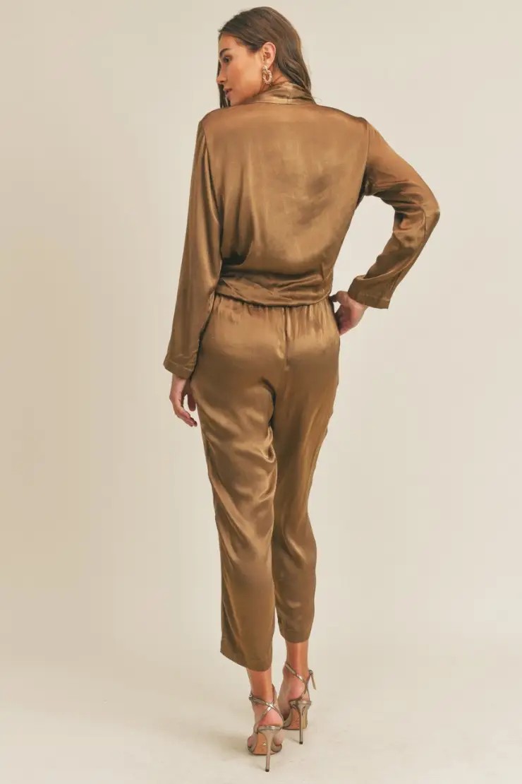 Model is wearing an olive green jumpsuit 